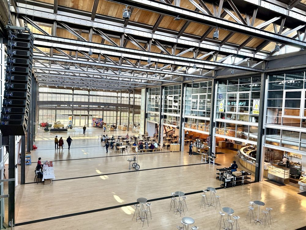 Pixar Emeryville campus atrium designed by Steve Jobs, showing an open collaborative workspace.